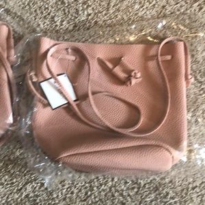 Macy’s pale pink drawstring handbag